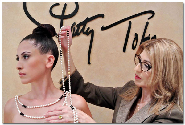Jewelry designer Patty Tobin drapes model in pearl and onyx ropes.